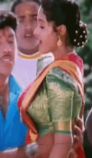 a woman in a green blouse is being held by two men