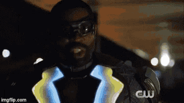 a man is wearing a glow in the dark jacket and glasses .