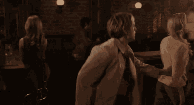 a man and a woman are dancing in a dark room