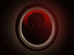 a dark circle with a red light in the middle