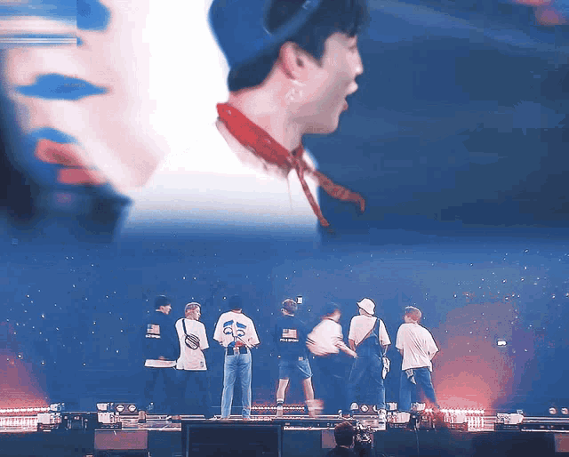 a group of people are standing on a stage with one wearing a shirt that says ' army ' on it