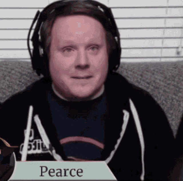 a man wearing headphones holds a sign that says pearce