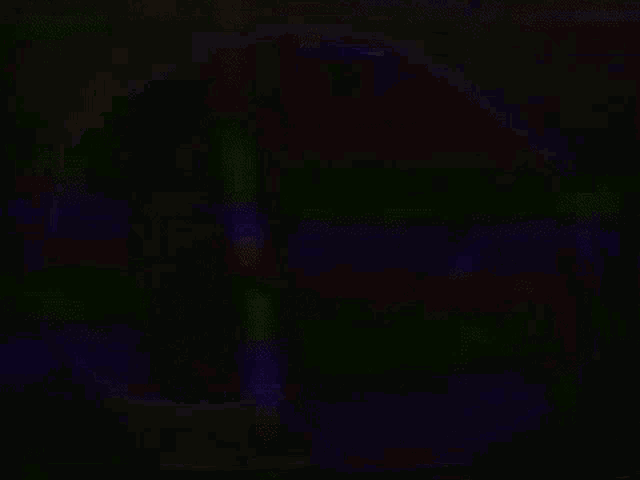 a rainbow of colors is being projected on a black background