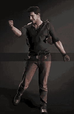 a man in a black shirt and brown pants holds his fist up