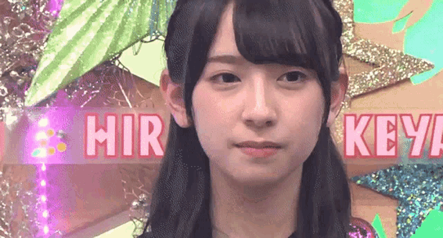 a girl is standing in front of a sign that says ' hir keya ' on it