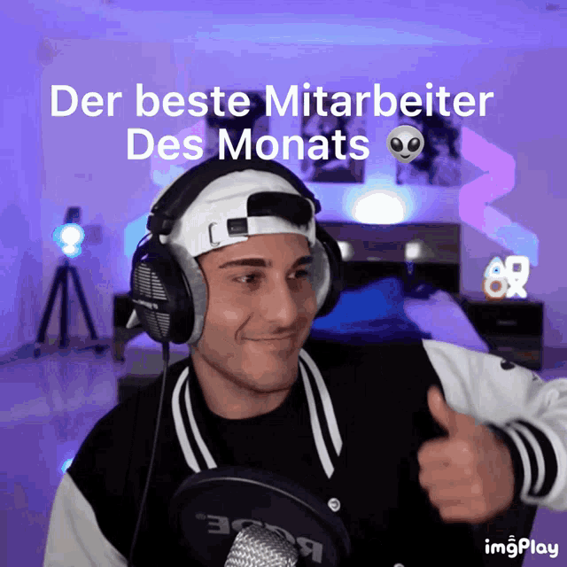 a man wearing headphones giving a thumbs up with the words der beste mitarbeiter des monats behind him