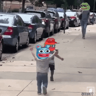 a person is walking down a sidewalk with a frog on their head .