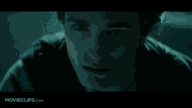 a movie clip from movieclips.com shows a man standing in a dark hallway