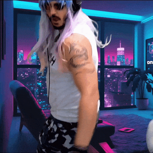 a man with a tattoo on his arm is dancing in front of a window that says on