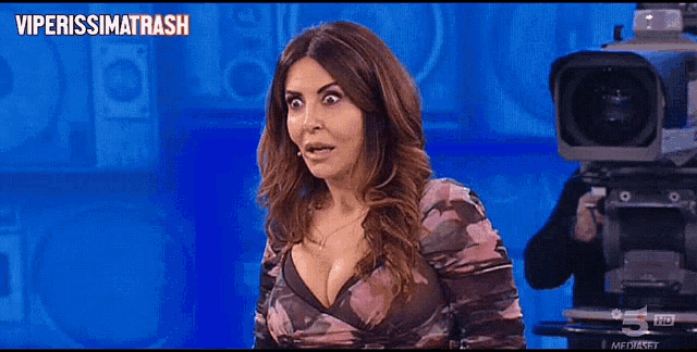 a woman sitting in front of a camera with the words viperissimo trash on the bottom right