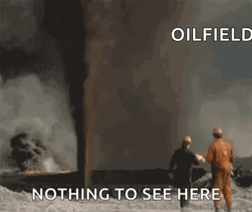 a man is standing in front of a large fire with the words nothing to see here written below him .