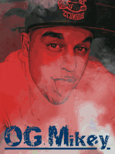 a man wearing a hat with the name og.mikey on the bottom