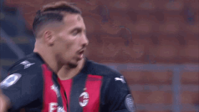 a blurred image of two soccer players with the words futball karim in the corner
