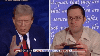 a man is playing a video game while watching the presidential debate