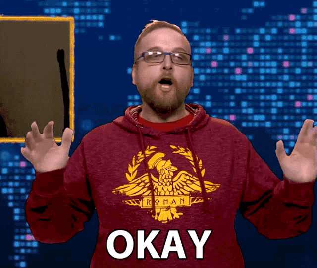 a man wearing a red hoodie that says roman on it