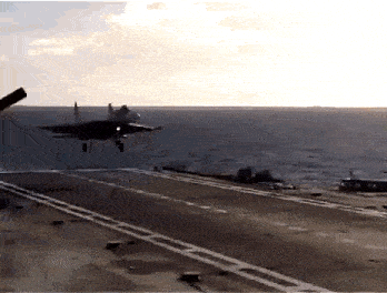 a fighter jet is taking off from the runway of an aircraft carrier