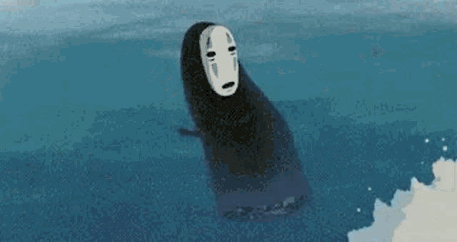 no face is floating in the ocean with a black mask on his face .