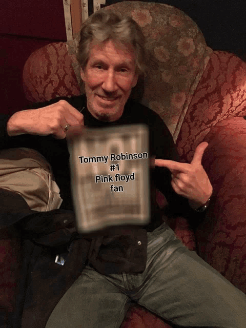tommy robinson # 1 pink floyd fan sitting on a chair