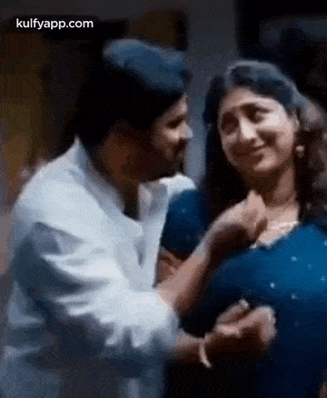 a man is putting his hand on a woman 's breast .