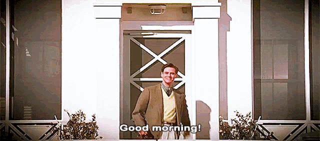 a man standing in front of a door that says " good morning " on it