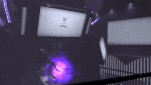 a screen with a sad face on it and a purple light coming out of it