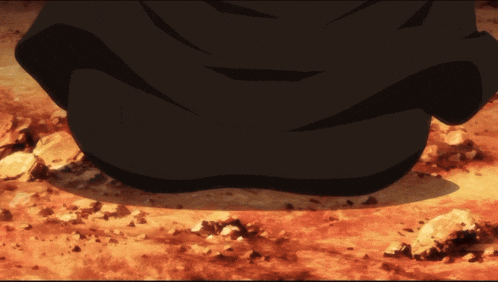 a person in a black suit is sitting on a rocky ground