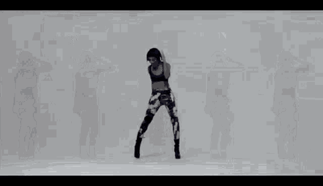 a row of women are dancing in a row with their arms in the air