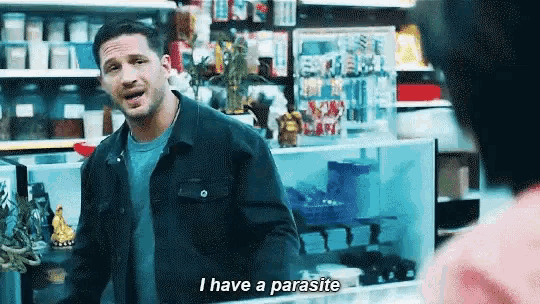 a man is standing in a store and talking to a woman .
