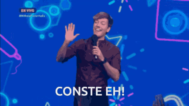 a man holding a microphone with the words conste eh on the bottom