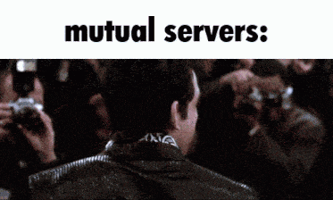 a man in a suit stands in front of a crowd with the words mutual servers below him