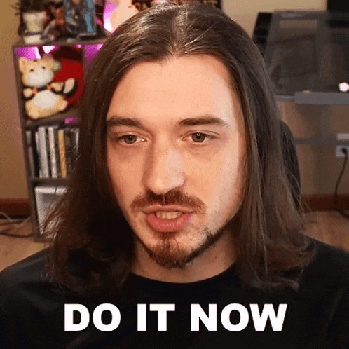 a man with long hair and a beard has the words do it now on his face