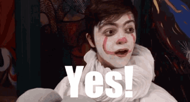 a man dressed as a clown with the word yes on his face