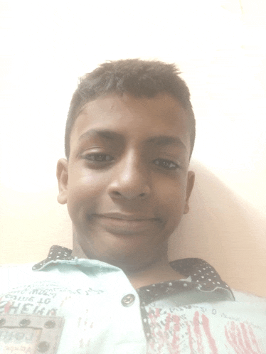 a young boy wearing a shirt that says ' denim ' on it