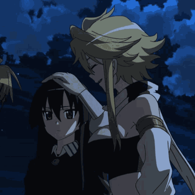 a girl with blonde hair is touching another girl 's hair