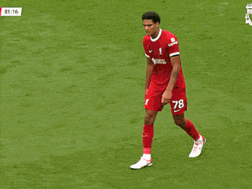 a soccer player is sitting on the grass with the time of 81:19 behind him