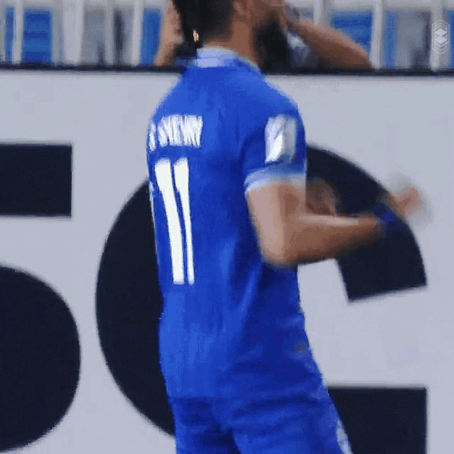 a soccer player in a blue jersey with the number 11 on it