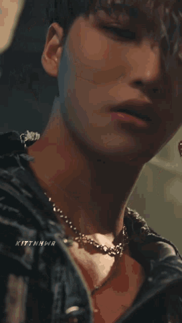 a close up of a person 's face with the name kittnhwa written on the bottom