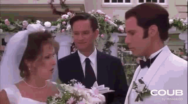 a bride and groom are standing next to each other at their wedding .