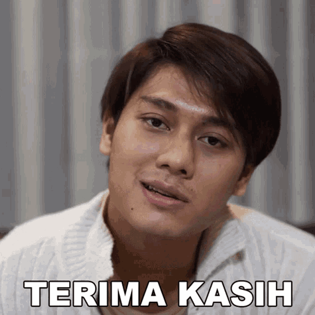 a man in a white sweater says " terima kasih " in white letters