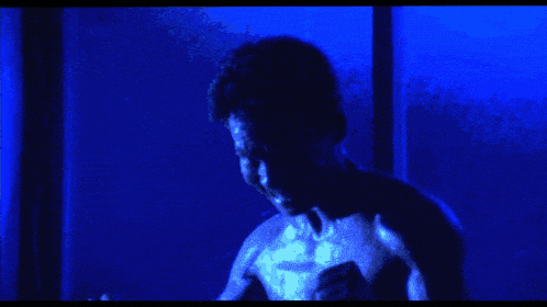 a close up of a person 's face with their eyes glowing blue