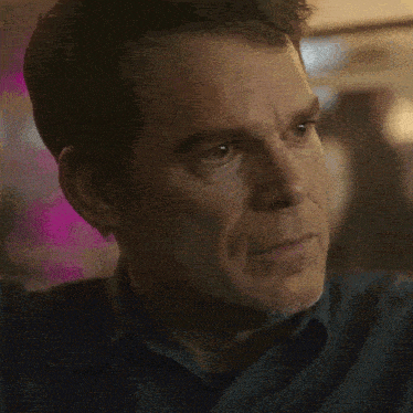 a close up of a man 's face with his eyes closed and his mouth open