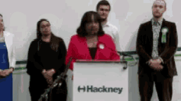 a group of people are standing around a podium that says hackney on it