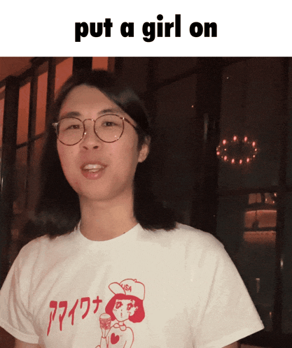 a man wearing glasses and a shirt that says put a girl on is smiling