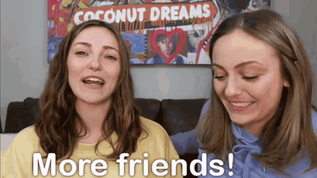 two girls are talking in front of a coconut dreams poster