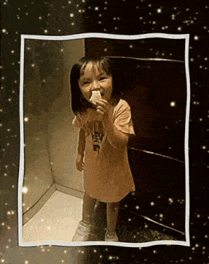 a little girl with a shirt that says ' angry birds ' on it is eating something