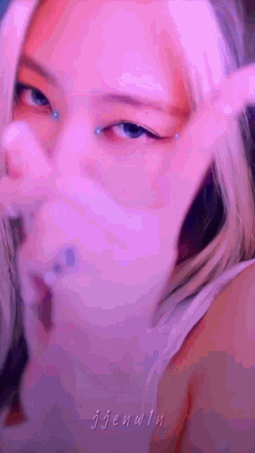 a close up of a person 's face with a pink background