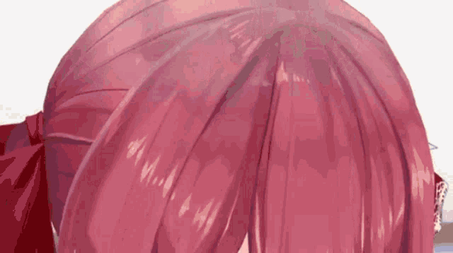 a close up of a person 's head with red hair and a red bow .