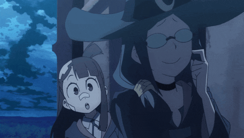 a witch with glasses and a crescent moon on her hat talks on a cell phone
