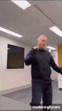 a man is dancing in a room with a window .