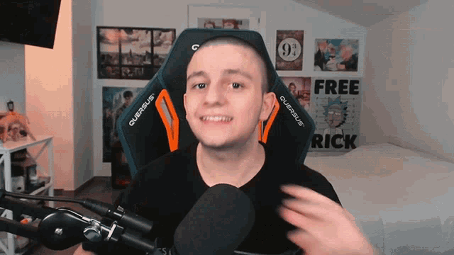 a man sitting in front of a microphone with a poster that says free rick on it